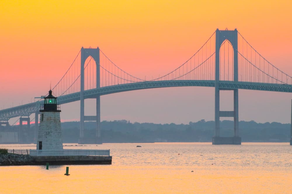 A bridge over a large body of water at sunset