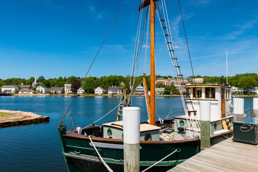 A fishing boat parked at a dock in a body of blue water