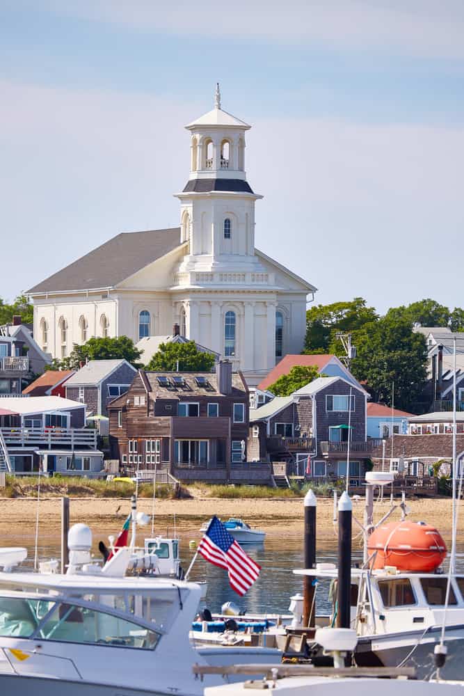 Boats parked in front of a buildings with a white church behind them