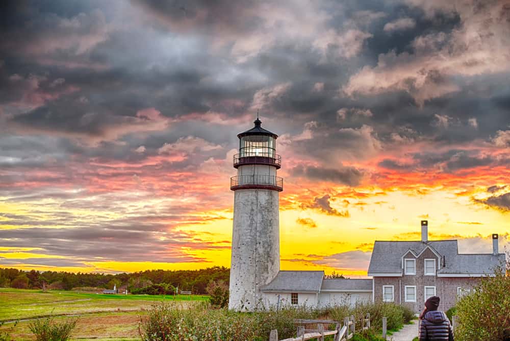 A lighthouse in front of a beautiful sunset