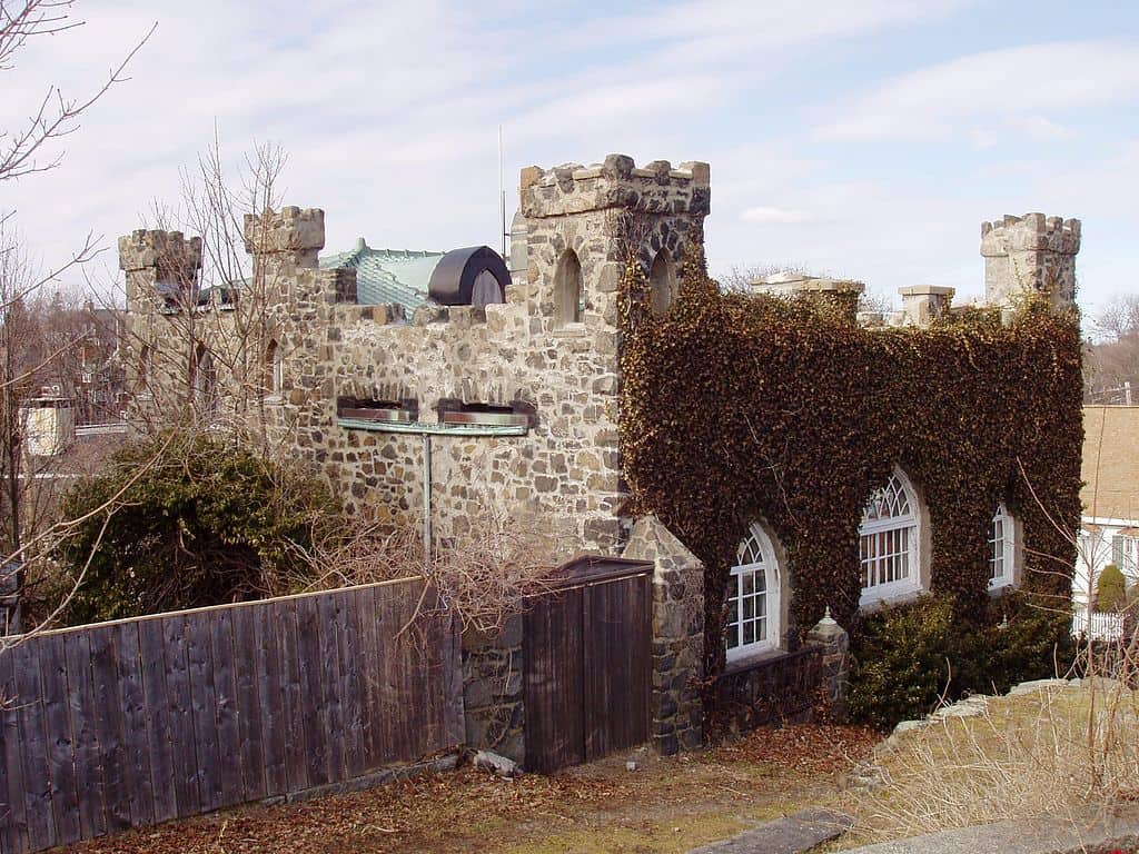 A wooden stockade fence next to a castle