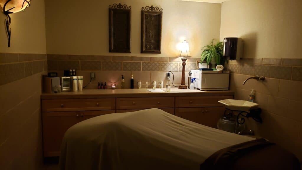 A spa room with a massage table and low lights at an inn in New Hampshire