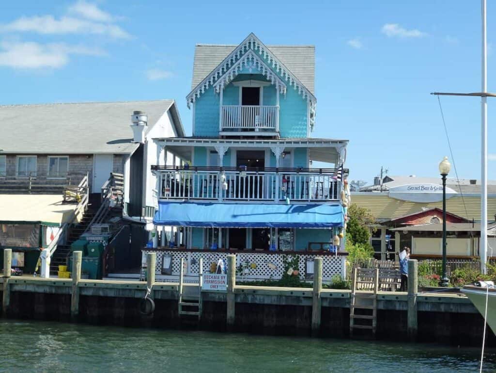 A blue building at the edge of a dock