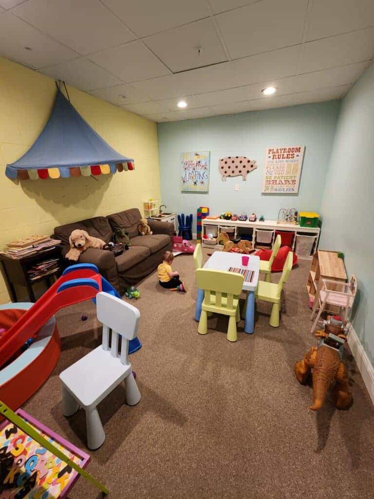 An indoor play space with miniature furniture and toys for toddler at 506 on the River Inn