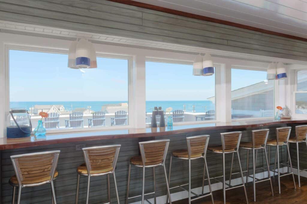 A row of chairs at a counter offers views of the ocean outside
