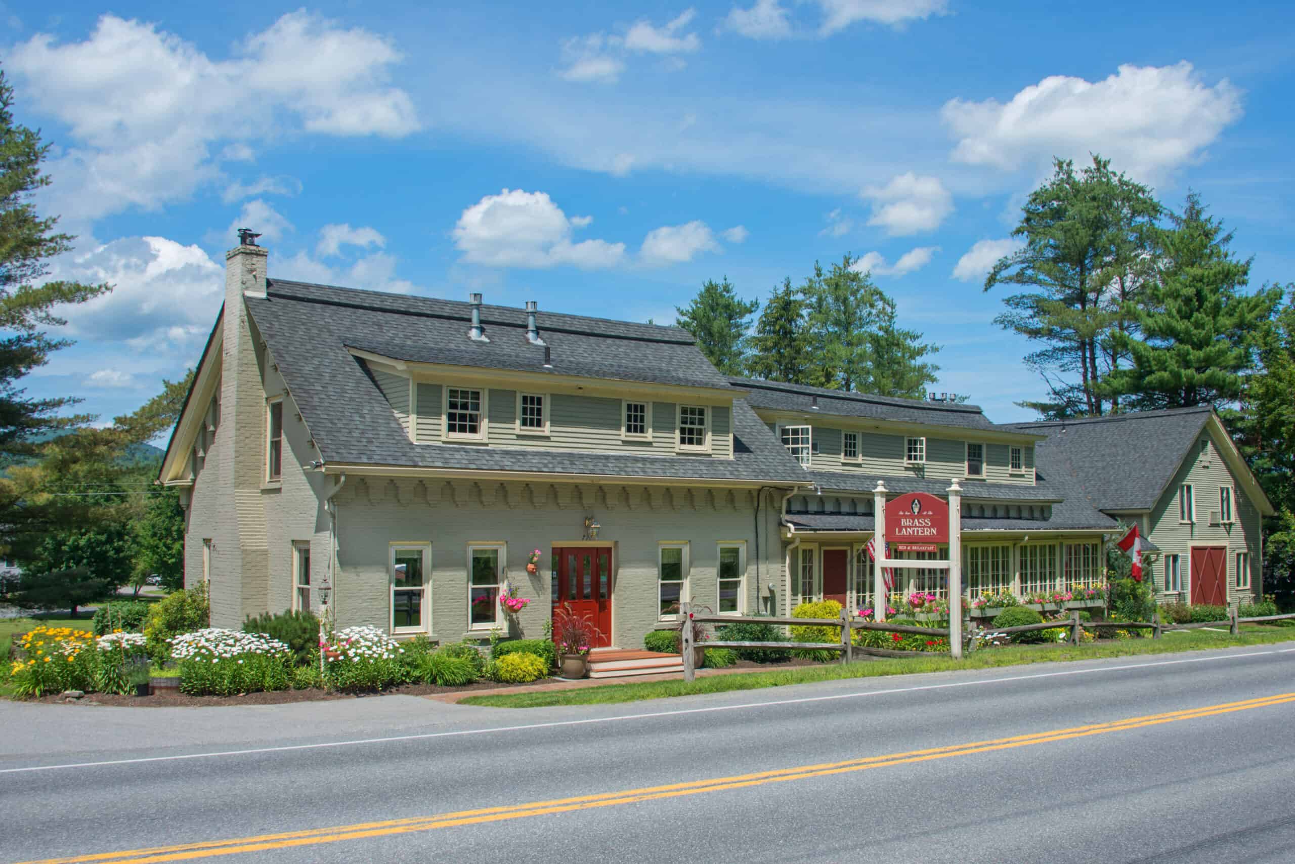 Grey building with red door and sign out front