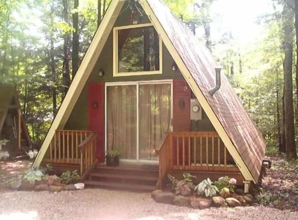 Green and red a-frame cabin in the woods