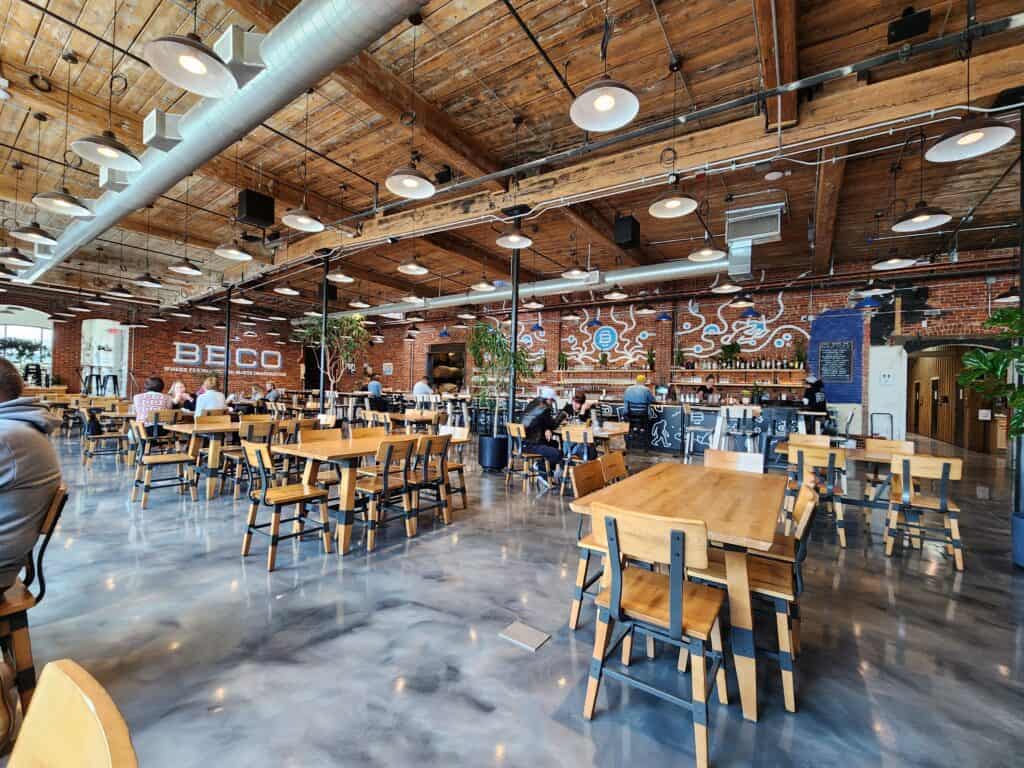 interior of a brewery restaurant, light wooden tables in an industrial, but cozy space