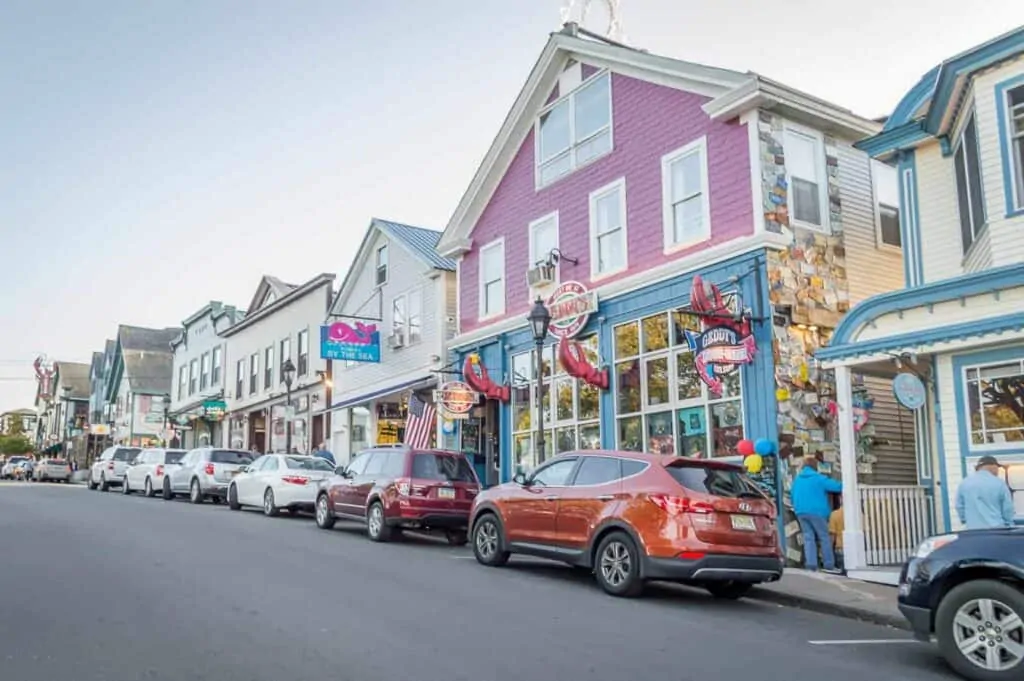 A street in Bar Harbor Maine with shops and cars parked alongside