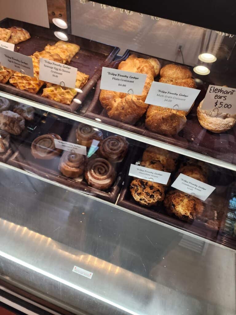 a bakery case shows two rows of pastries