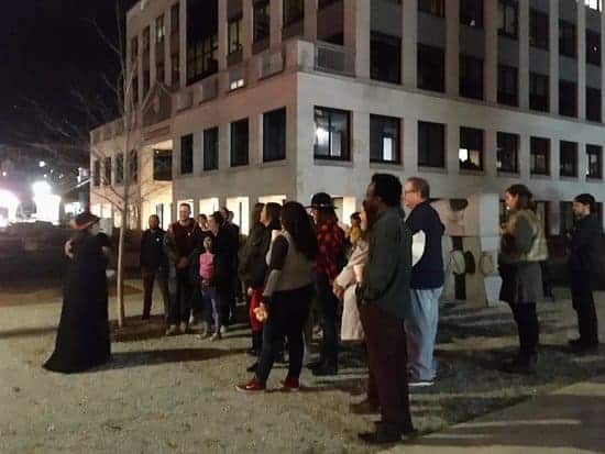A group of people gather for a ghost tour in Burlington VT