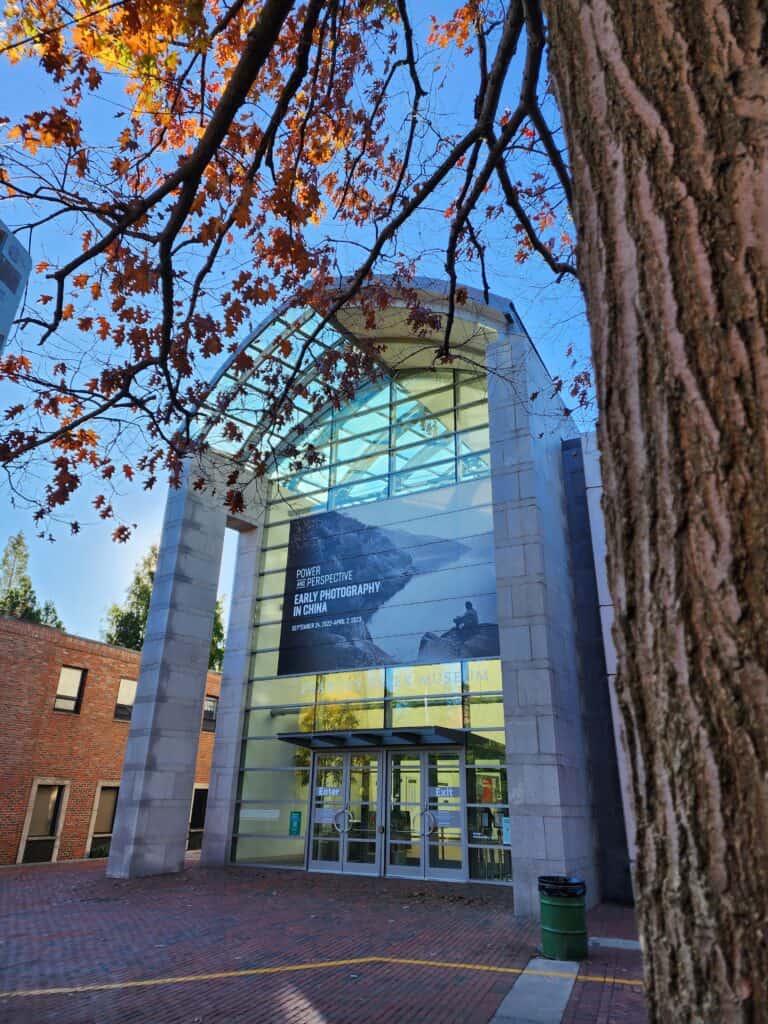 exterior entrance of the Peabody Essex Museum, framed by a fall tree