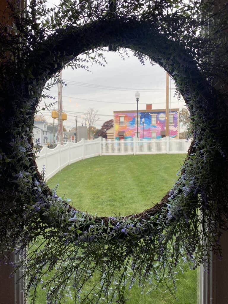 A colorful building in Milford, Connecticut as seen through a circle wreath.