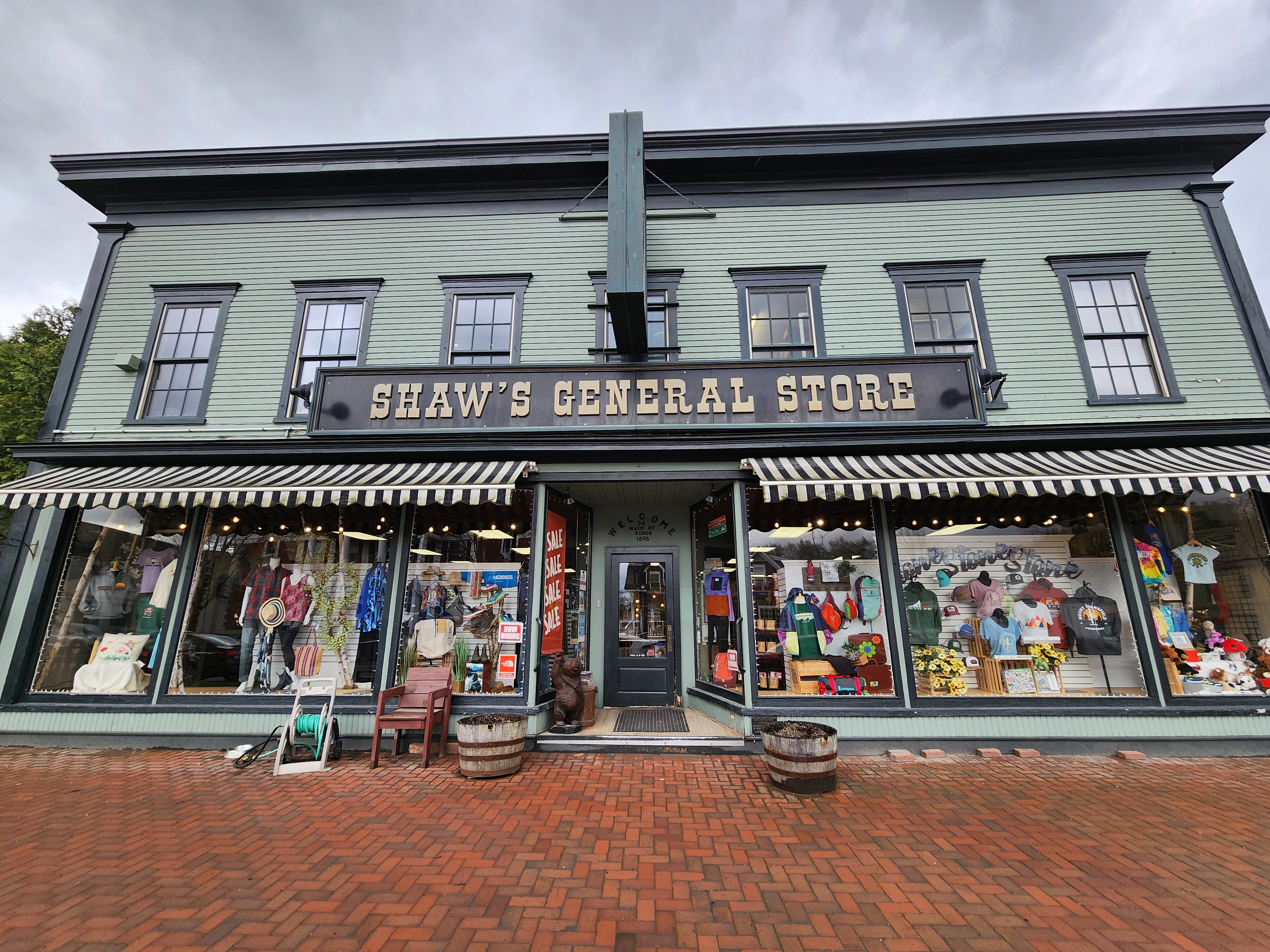 exterior of a historic-looking storefront on a green building with a sign reading Shaw's General Store