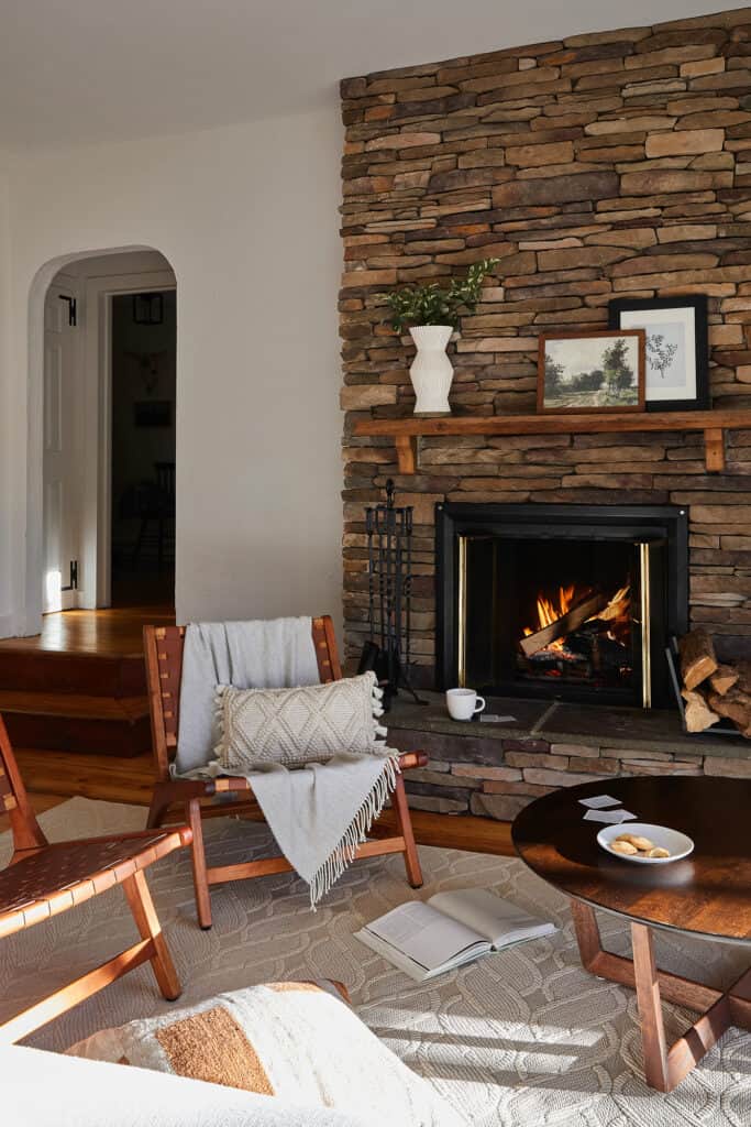 A cozy scene with a fire roaring in the fireplace at a Berkshires MA cabin