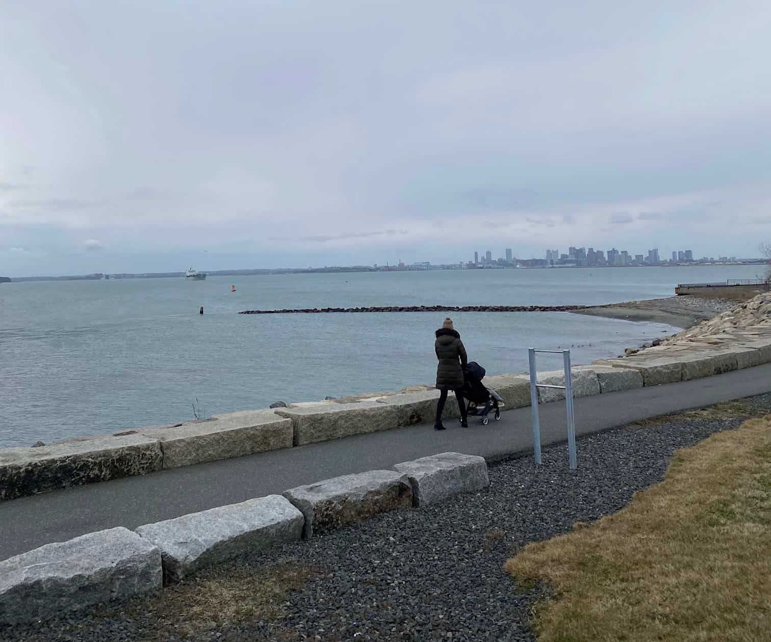 Person walking on a path by the water