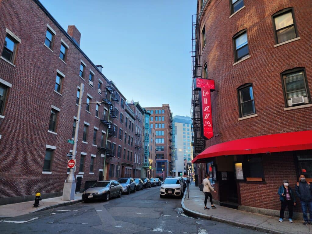 An exterior shot of a brick building that houses a popular pizzeria in Boston's North End neighborhood