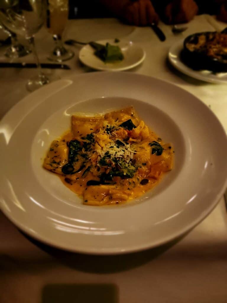 An authentic Italian pasta dish at Lucca's in Boston's North End is seen illuminated on a table with candlelight