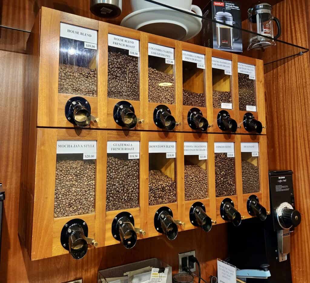 An assortment of coffee beans at a New Haven coffee shop is seen behind glass with individual dispensers