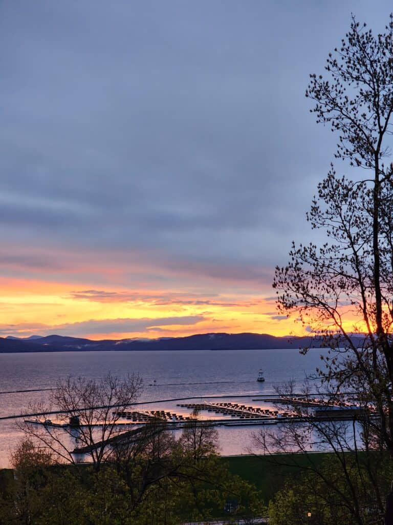 A purple and orange sunset over Lake Champlain at the Burlington waterfront