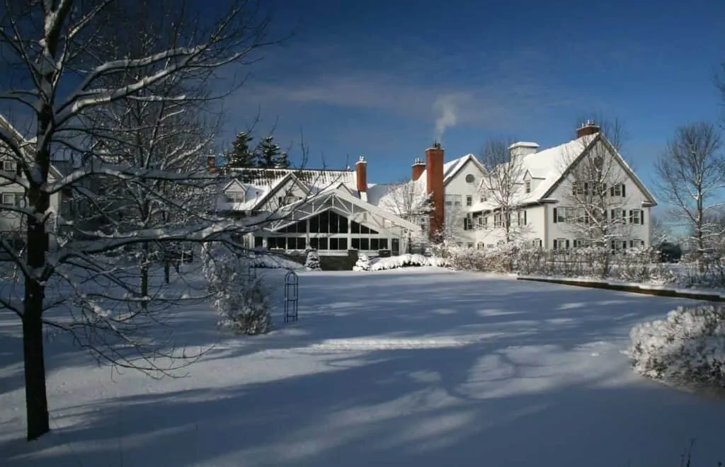 A large resort and spa near Burlington, Vermont sits covered in snow under a blue sky
