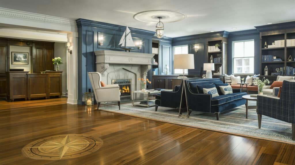 The lobby of a nautical themed historic hotel in Portland, Maine features deep blue walls and creme colored accents