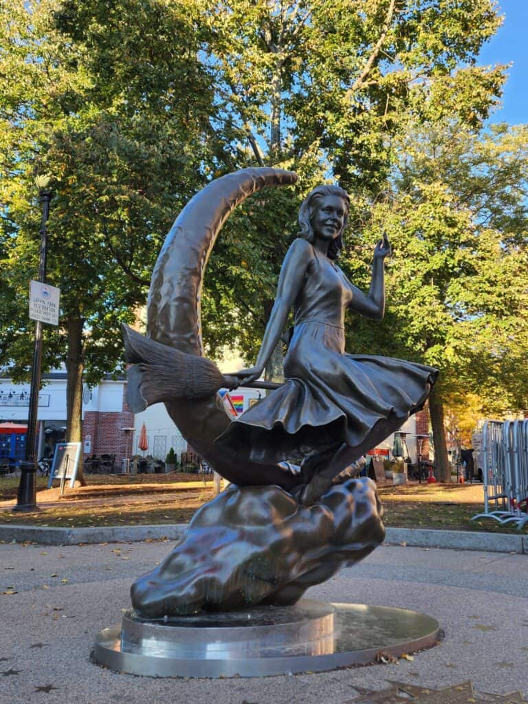 A statue of iconic Bewitched actress on a crescent moon with broom sits visible on one of the best tours in Salem, Massachusetts.