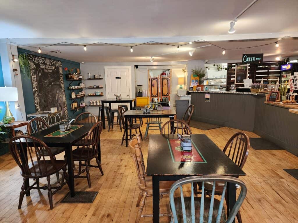 interior of a charming casual restaurant, several tables sit empty