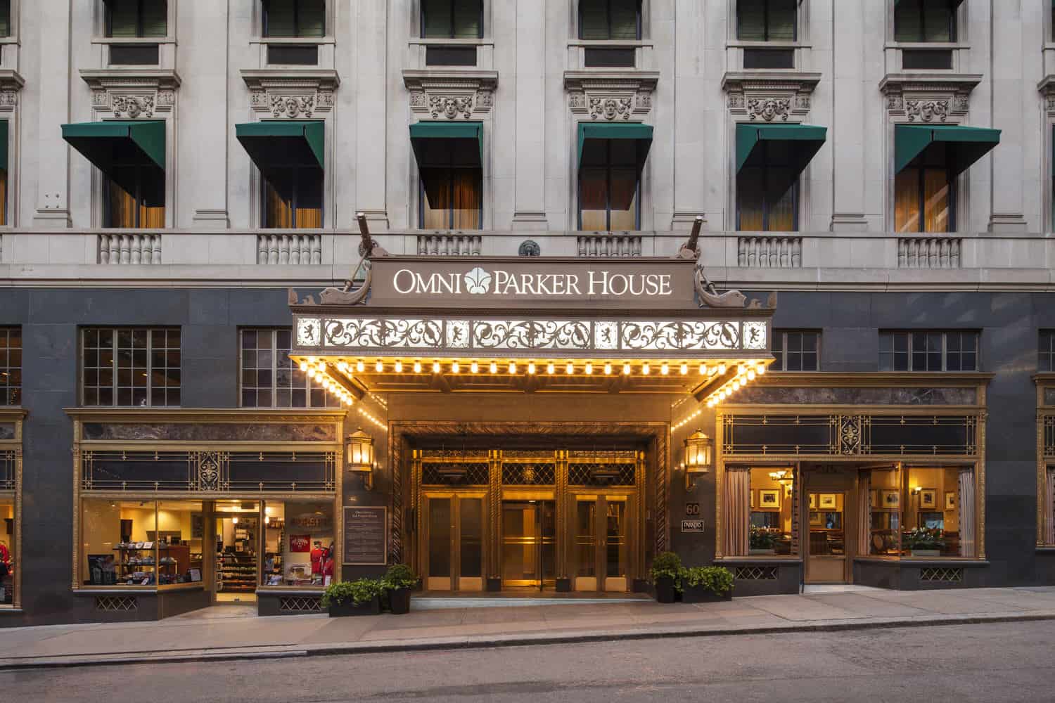 Exterior of a hotel lit up that says "Omni Parker House."
