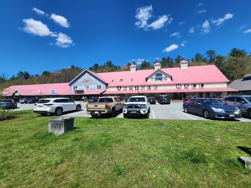 a long building with a pink roof, bearing a sign reading Antique Mall