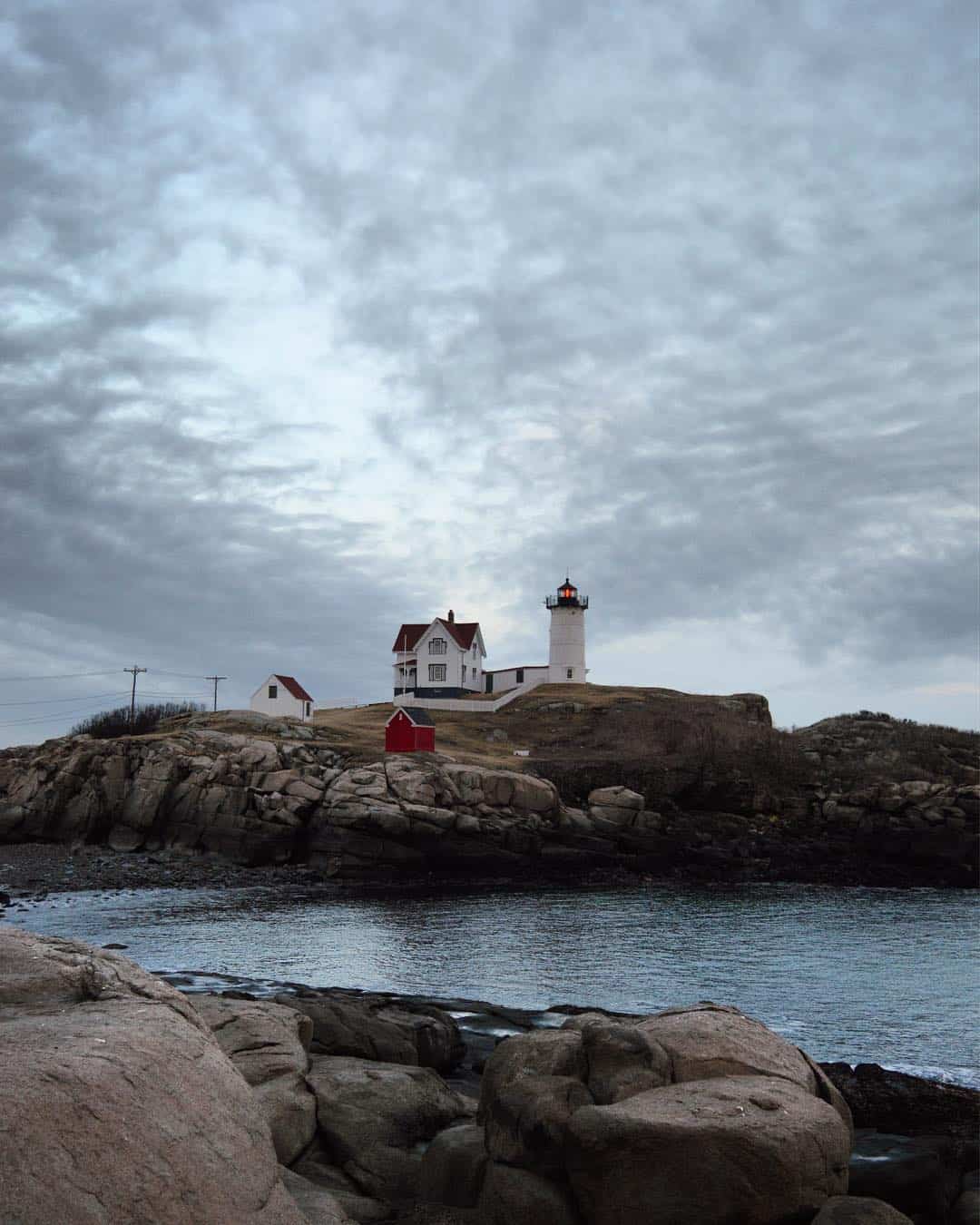 a cloudy evening at nubble lighthouse in york, maine