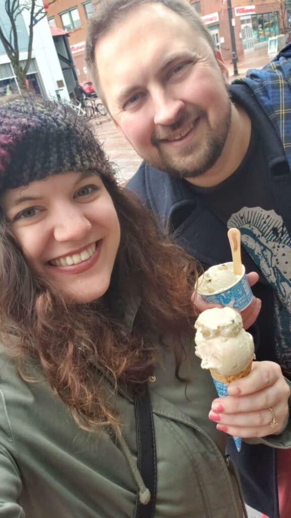 a woman and a man smiling and holding ice cream cones