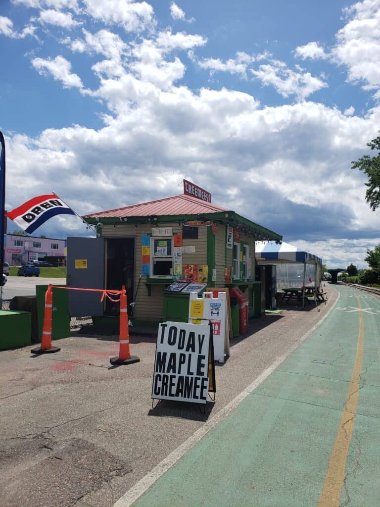 a sign reads today maple cremee in front of a small food shack