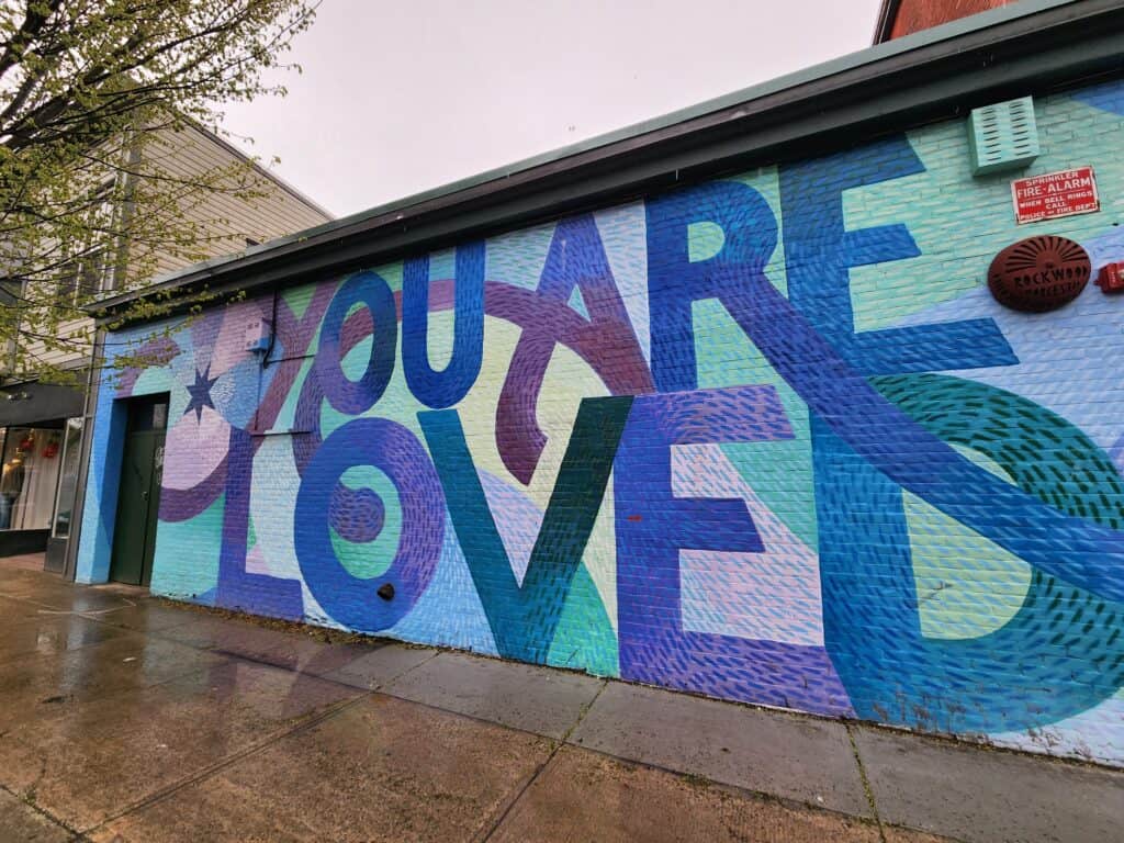 purple wall mural that says you are loved