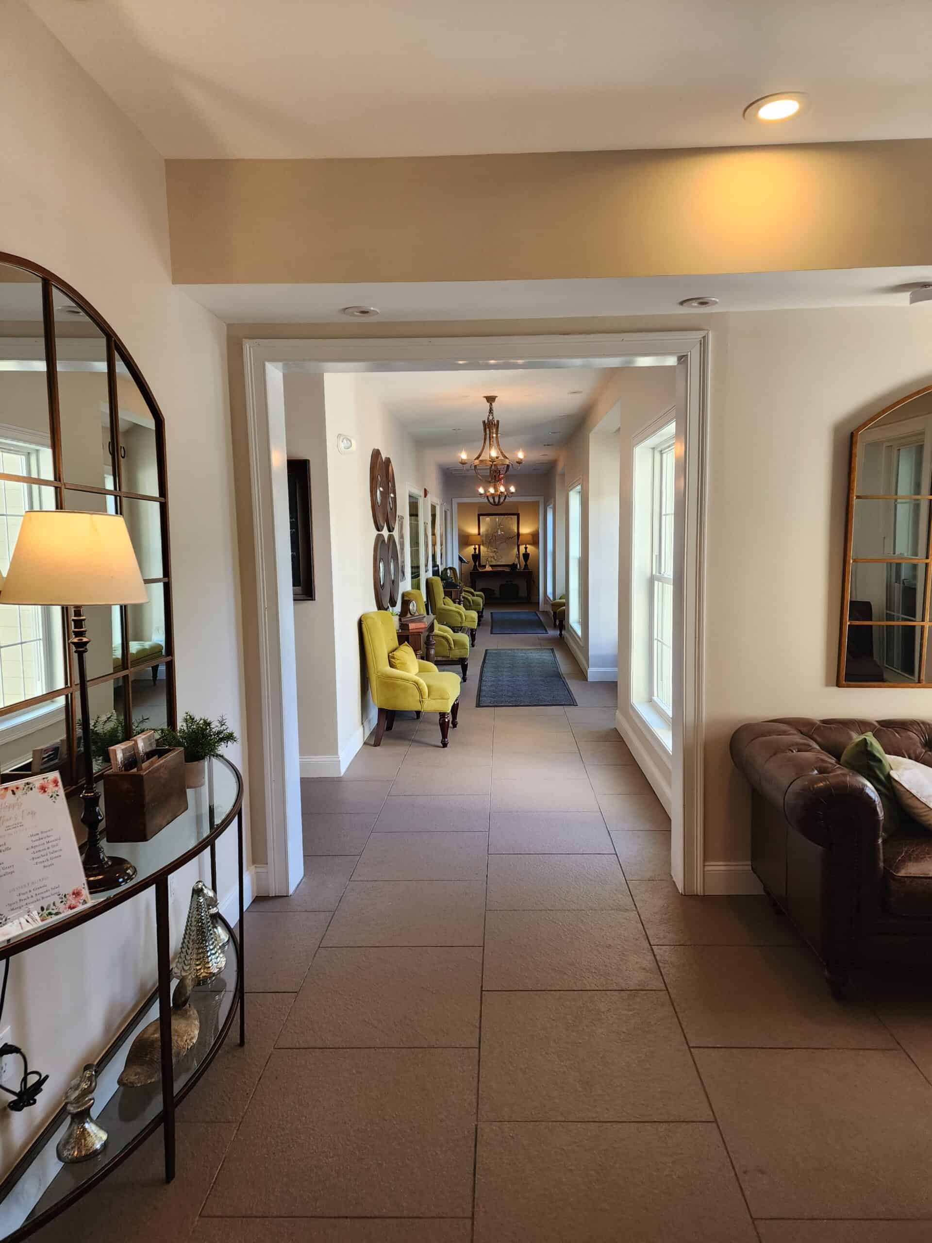 a hallway at a hotel looking towards rooms