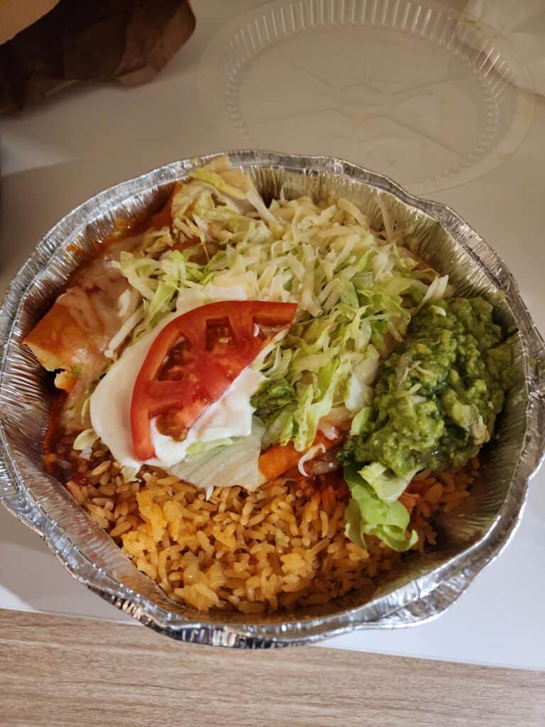 a takeout container filled with mexican food