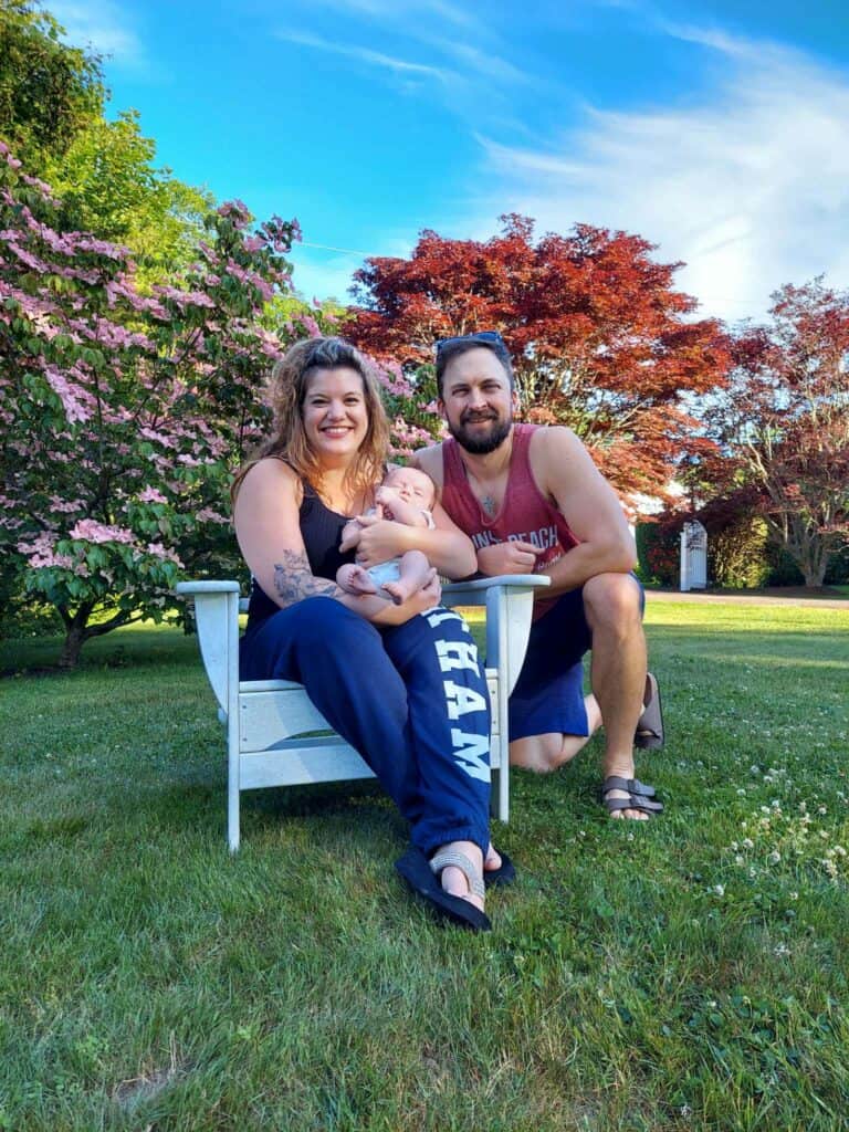 A family sits on a lawn in Chatham, Massachusetts on an early summer day