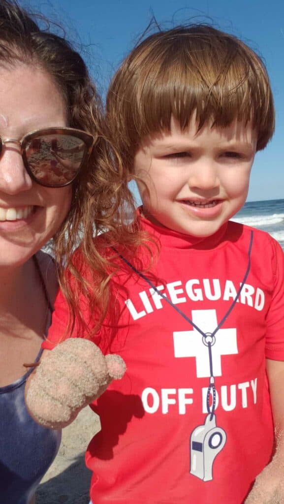 A woman and a toddler posing on a beach in Hampton, New Hampshire