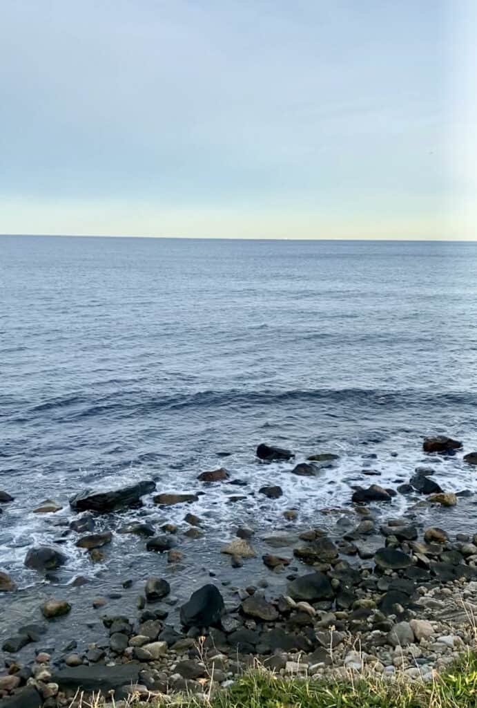 A rocky shoreline as seen from Point Judith Lighthouse in Narragansett, Rhode Island