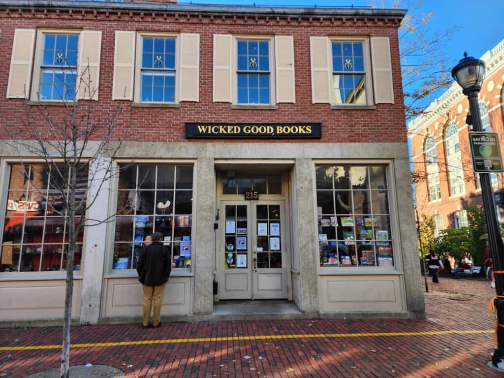 A brick storefront of a historic building that houses Wicked Good Books in Salem