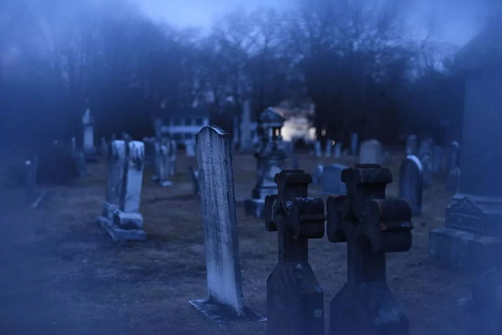 A haunted cemetery in Connecticut on a foggy night at twilight