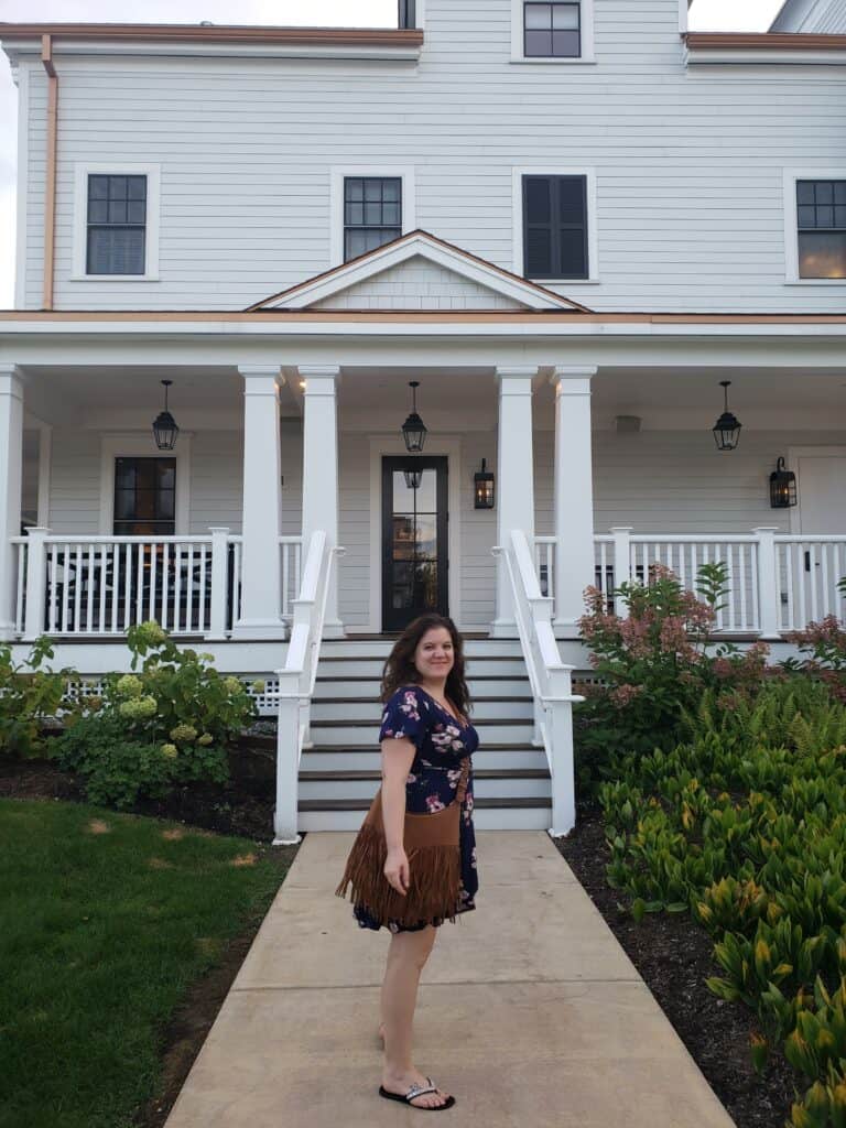 amy standing in front of the entrance to a pleasant hotel
