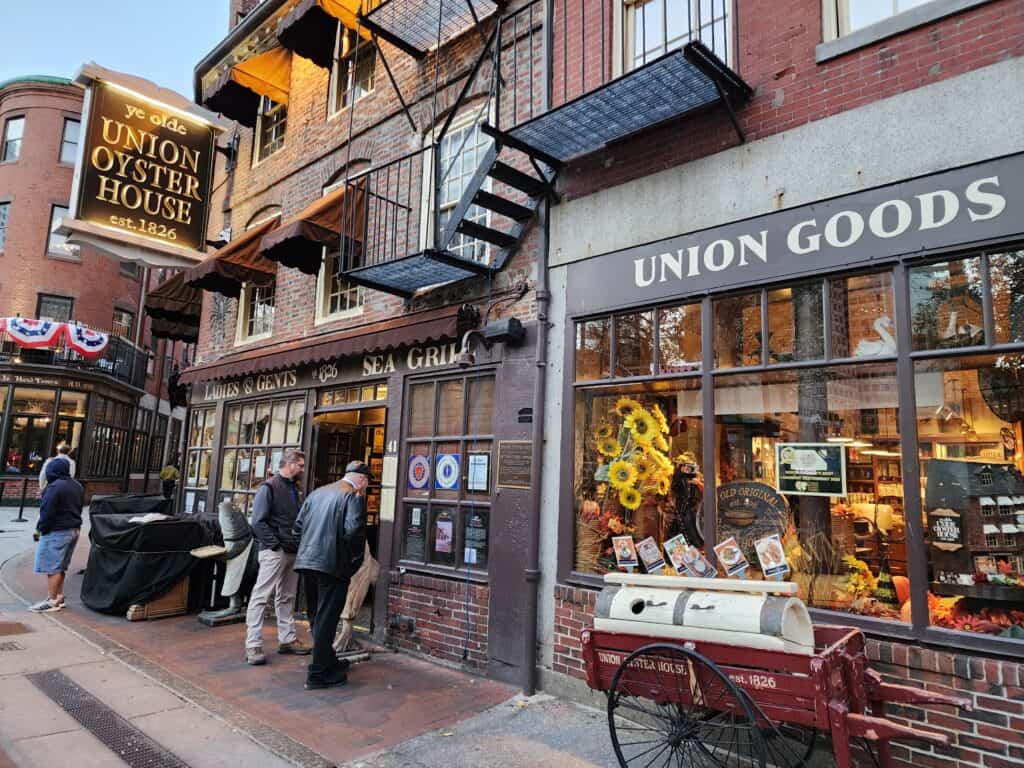 People on a street in Boston with signs for Union Oyster House 