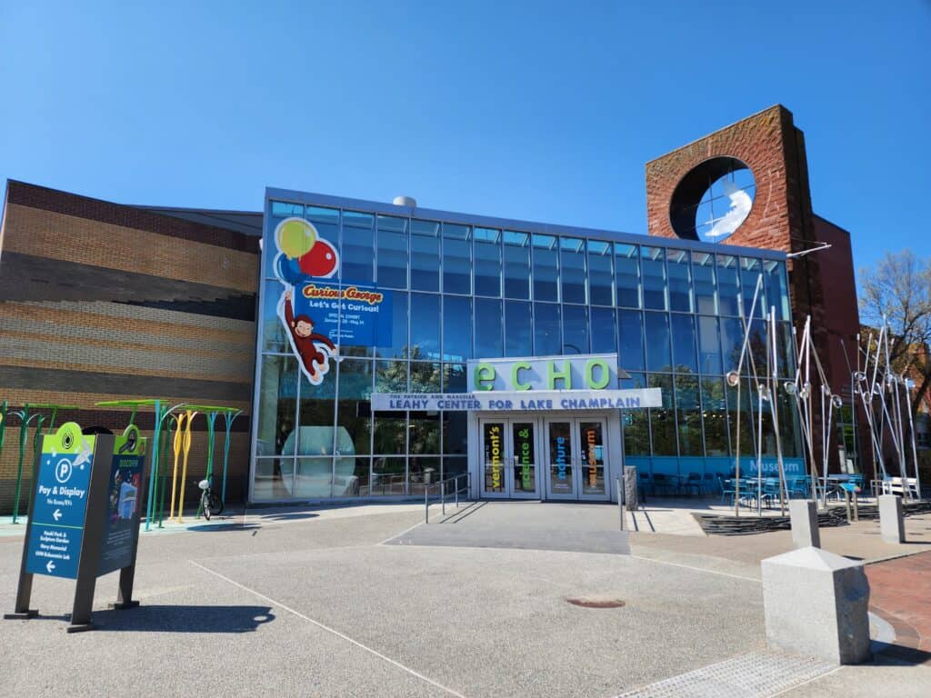 exterior of a museum and aquarium in burlington vt, echo leahy center for lake champlain - large glass front entry way and outdoor art exhibits