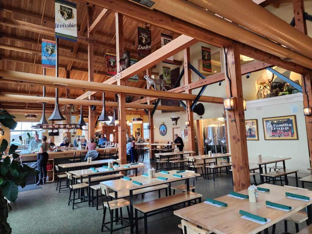 A large restaurant/brewery with high ceilings and rustic decor in Stowe, Vermont