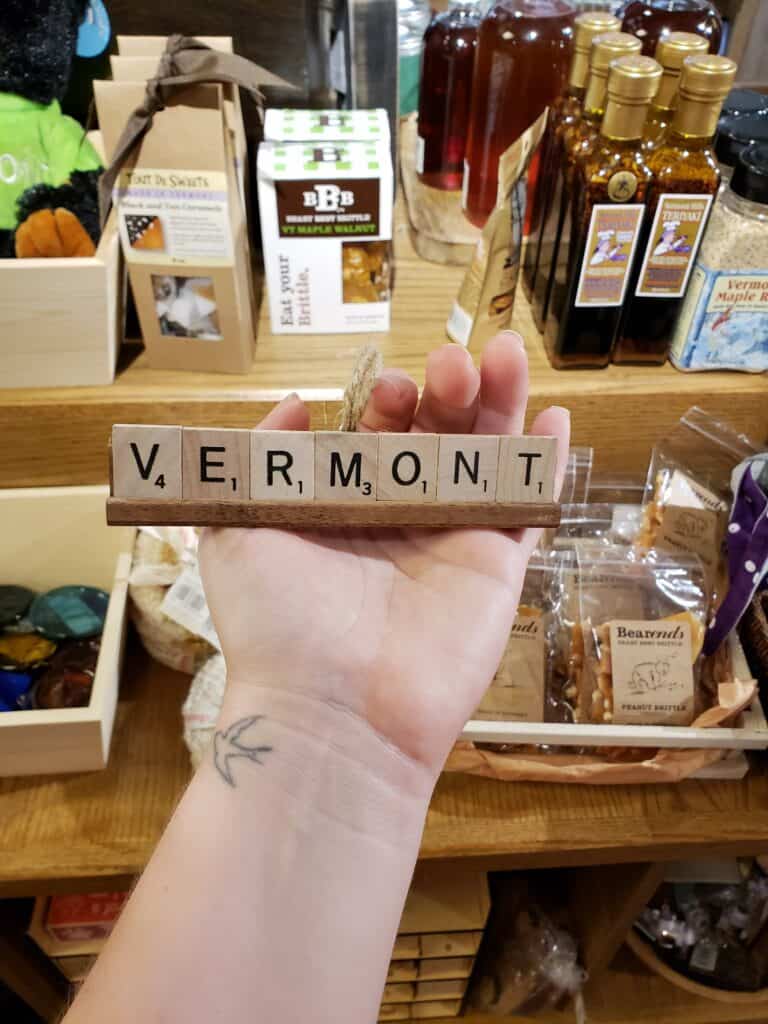 amy's hand holding scrabble tiles that say Vermont