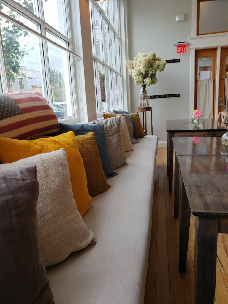 a long bench in a restaurant covered with pillows