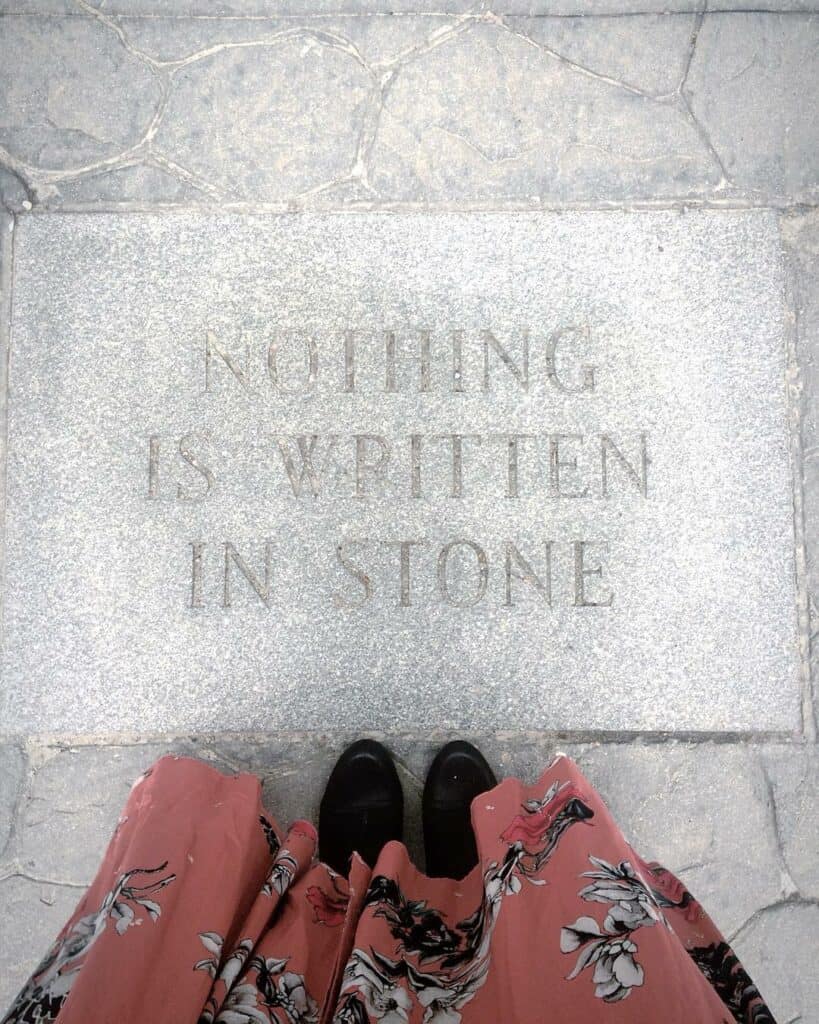 a stone pathway with an engraving "nothing is written in stone"