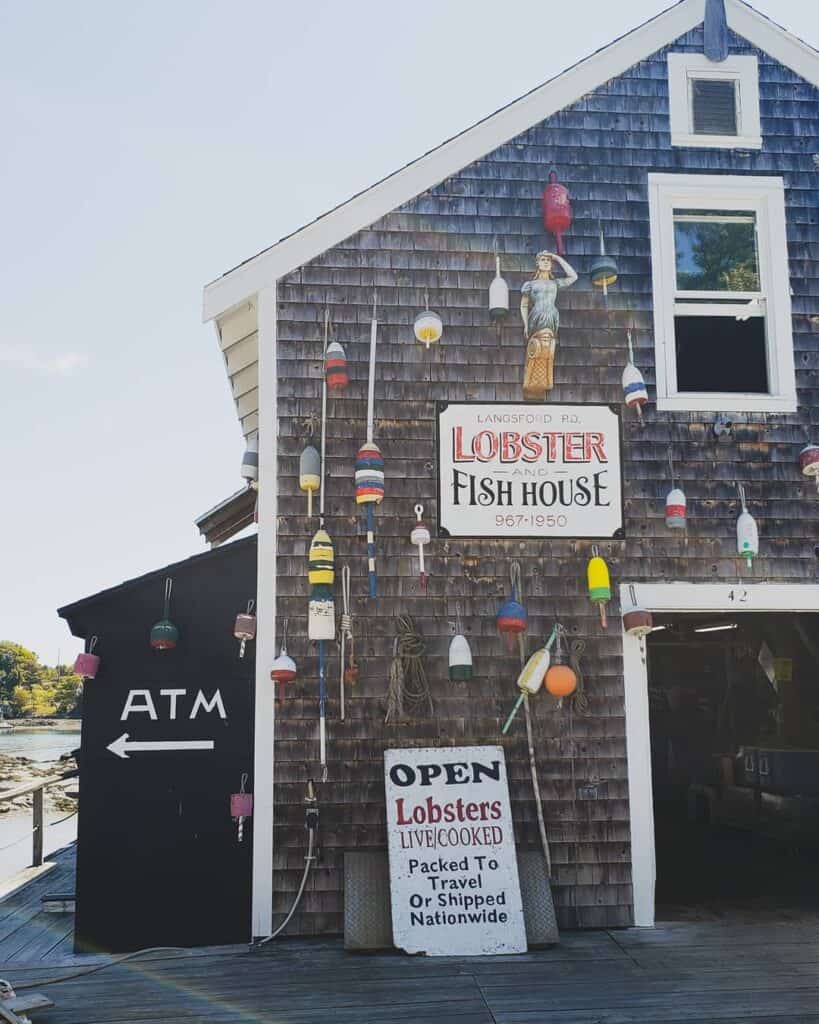 a maine lobster shack, decorated with buoys and worn shingle
