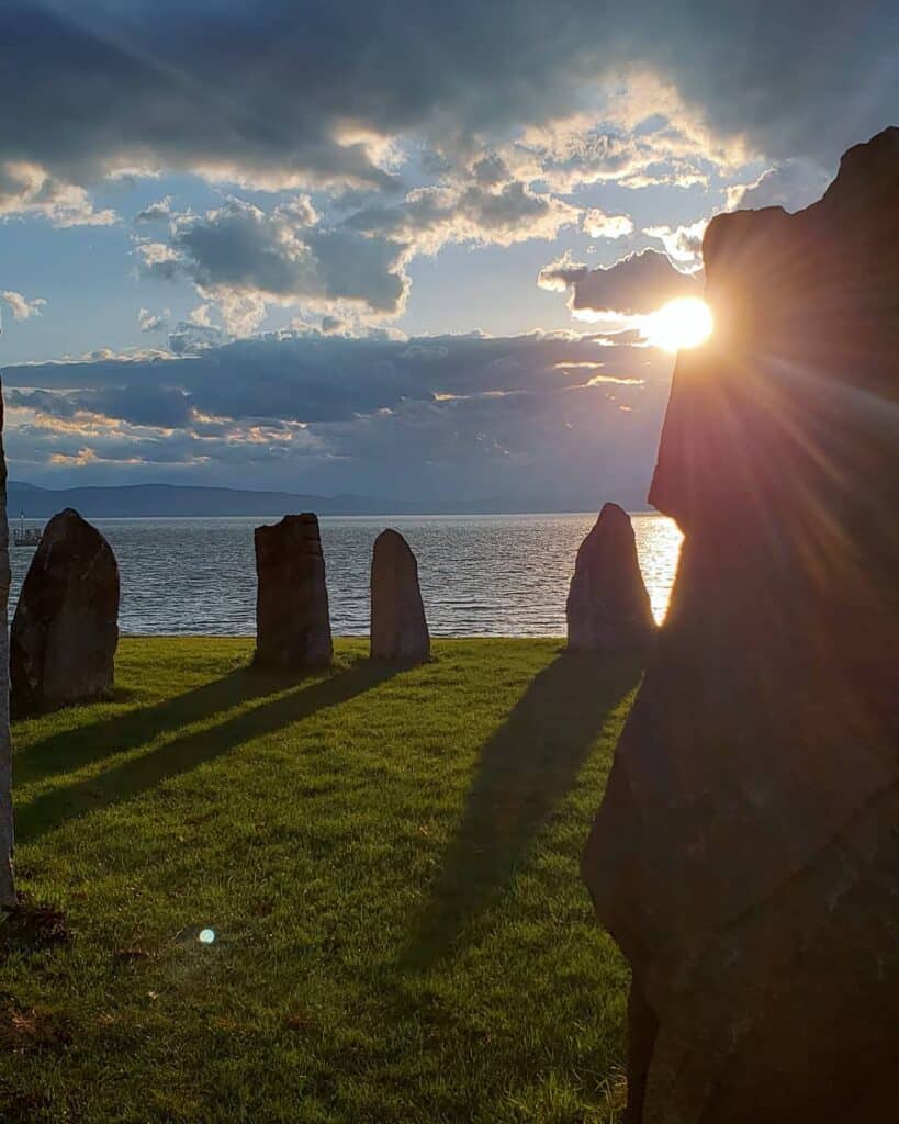 ancient looking standing stones on the shores of lake champlain at sunset